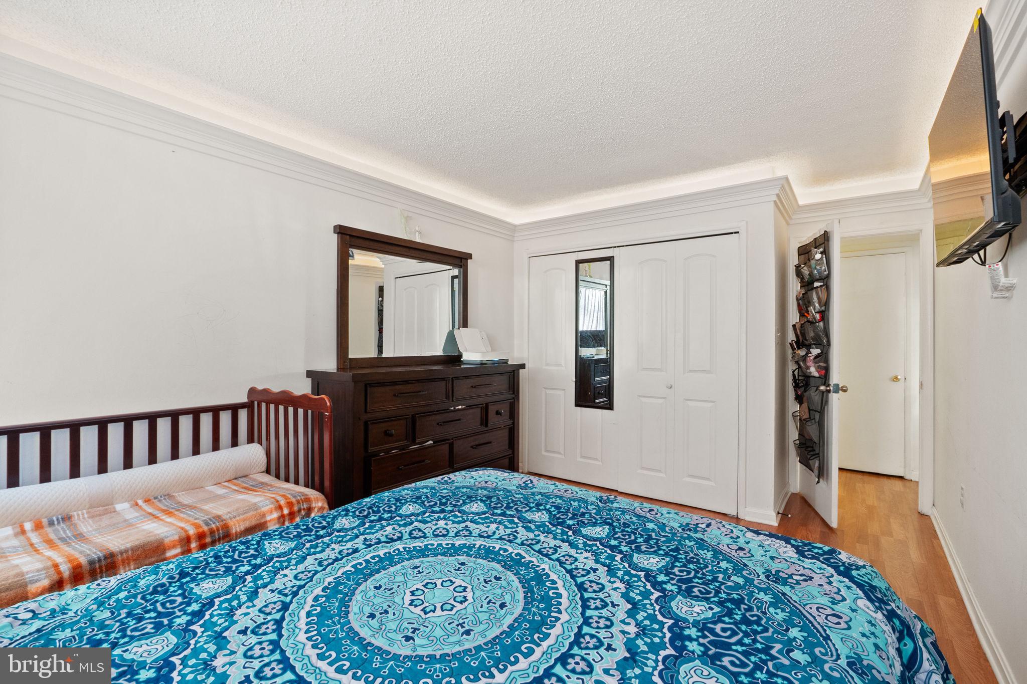1832 Metzerott Road, Unit 303 Adelphi, MD 20783 - Photo 18 of 22 a bedroom with a bed and wooden floor