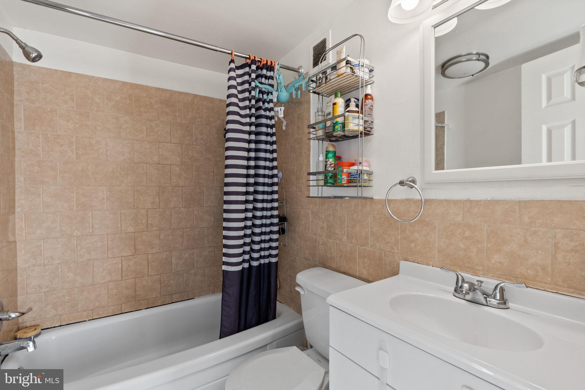 1832 Metzerott Road, Unit 303 Adelphi, MD 20783 - Photo 21 of 22 a bathroom with a bathtub and a shower