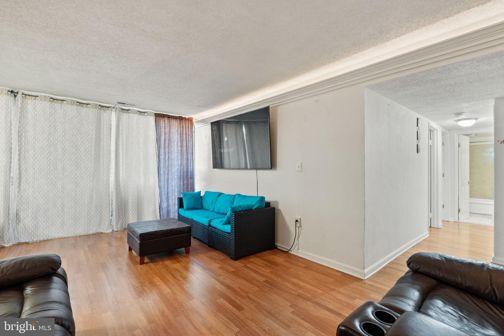 1832 Metzerott Road, Unit 303 Adelphi, MD 20783 - Photo 6 of 22 a living room with furniture and a wooden floor