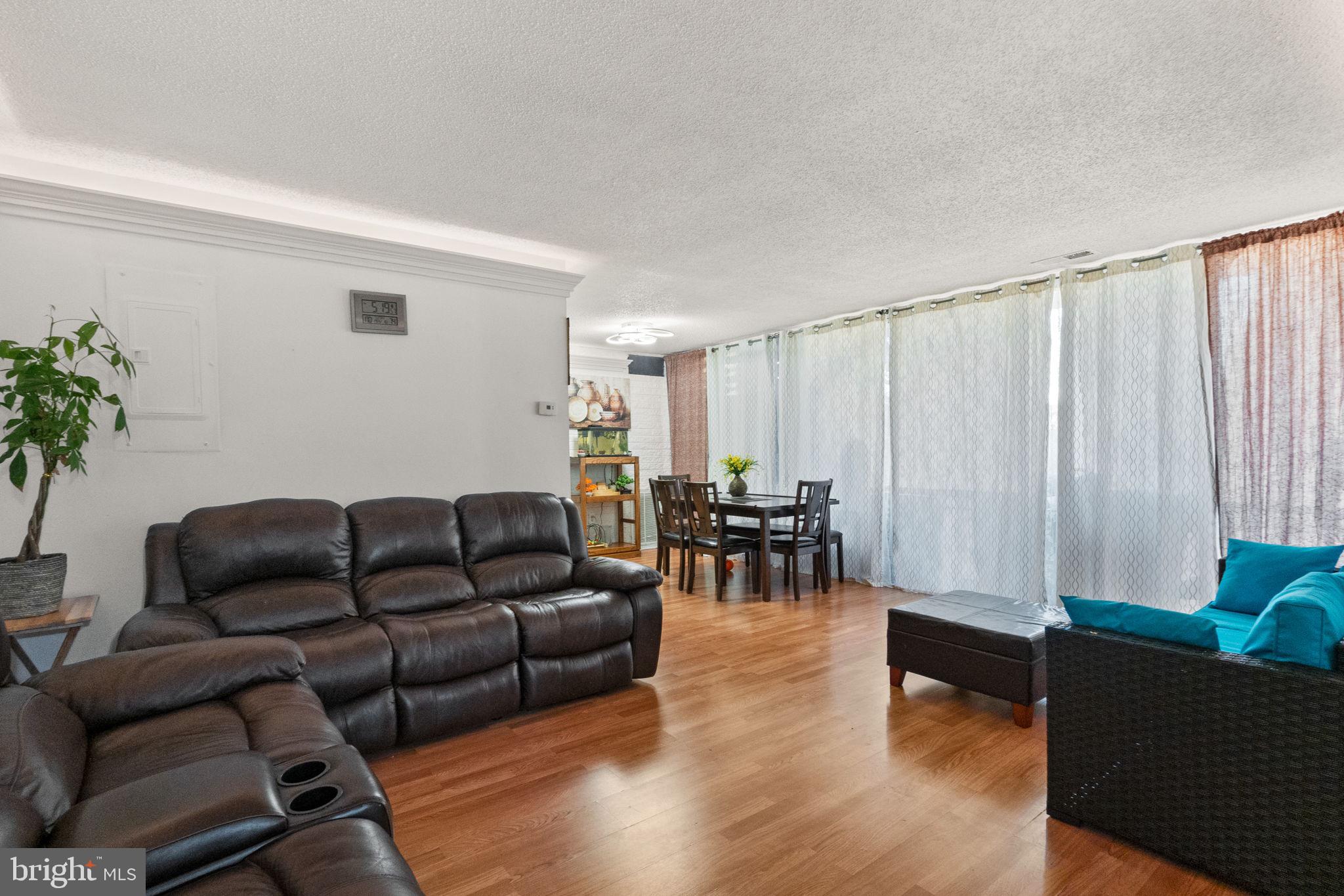 1832 Metzerott Road, Unit 303 Adelphi, MD 20783 - Photo 7 of 22 a living room with furniture and wooden floor