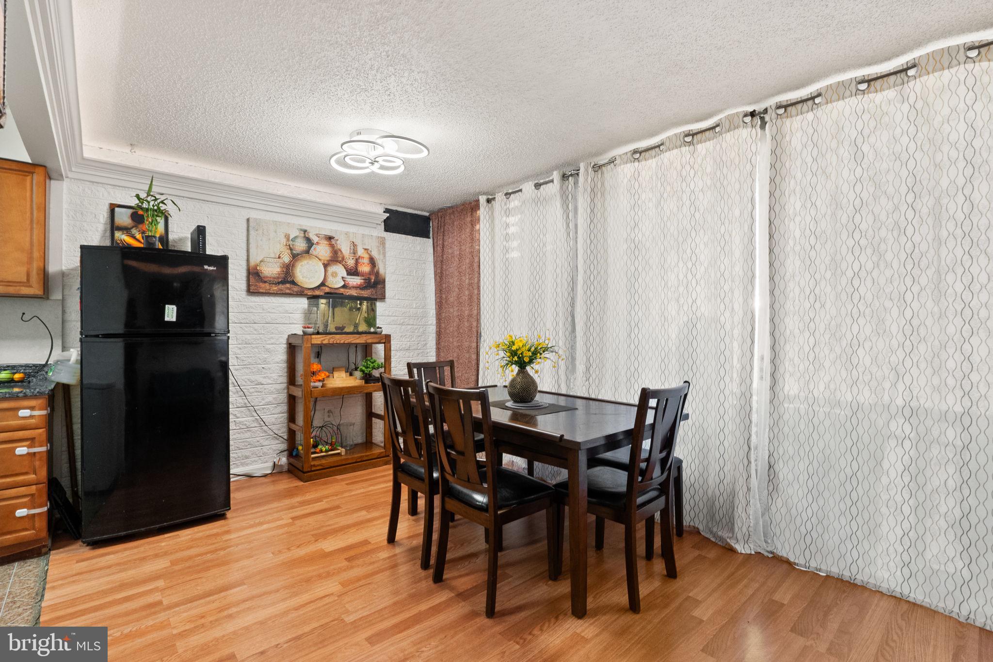 1832 Metzerott Road, Unit 303 Adelphi, MD 20783 - Photo 9 of 22 a view of a dining room with furniture window and wooden floor
