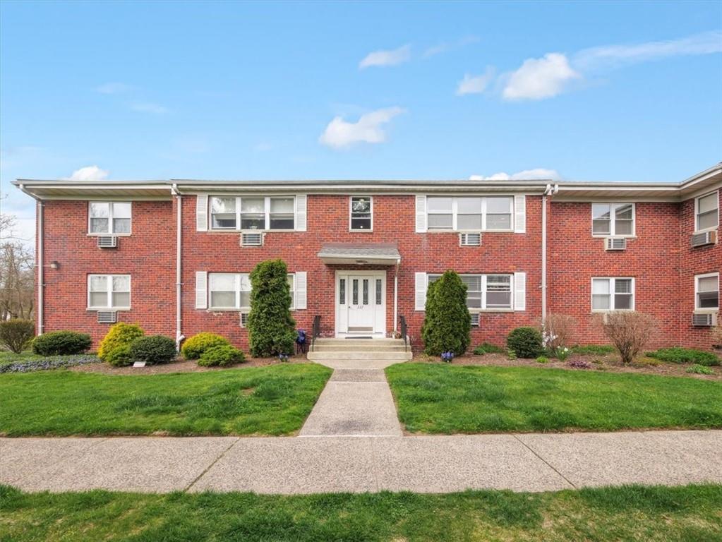 237 North Middletown Road, Unit H Pearl River, NY 10965 - Photo 1 of 1 a front view of brick house with yard