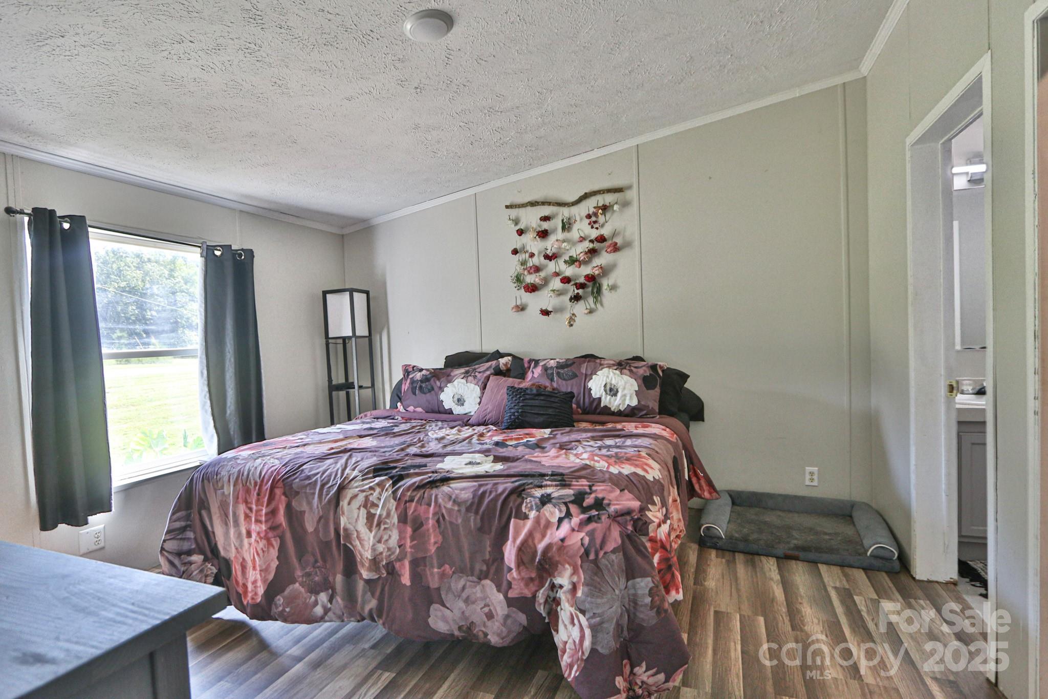 112 Courtney Road Mocksville, NC 27028 - Photo 11 of 31 a bedroom with a bed and wooden floor