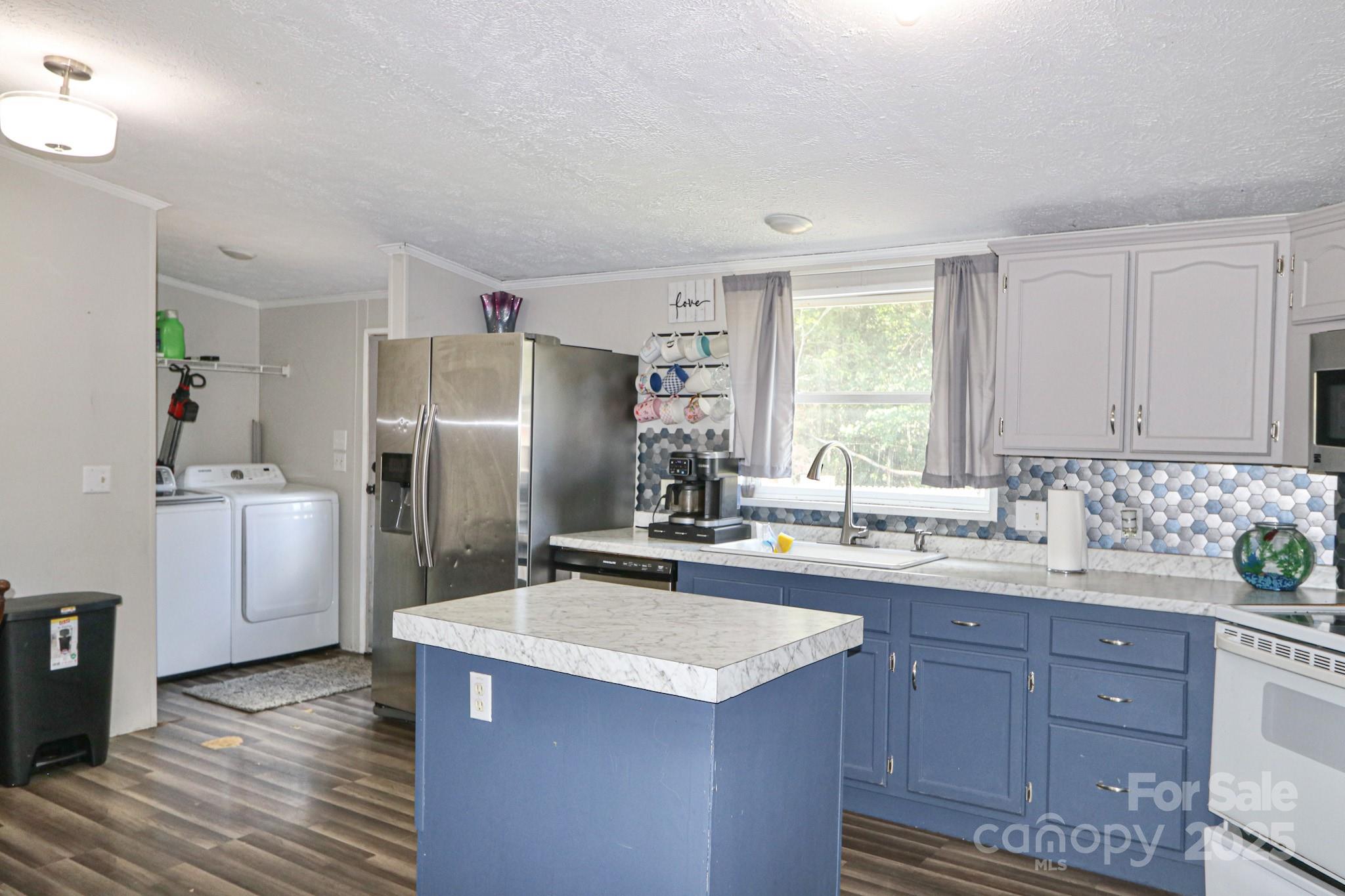 112 Courtney Road Mocksville, NC 27028 - Photo 21 of 31 a kitchen with a sink a refrigerator and cabinets