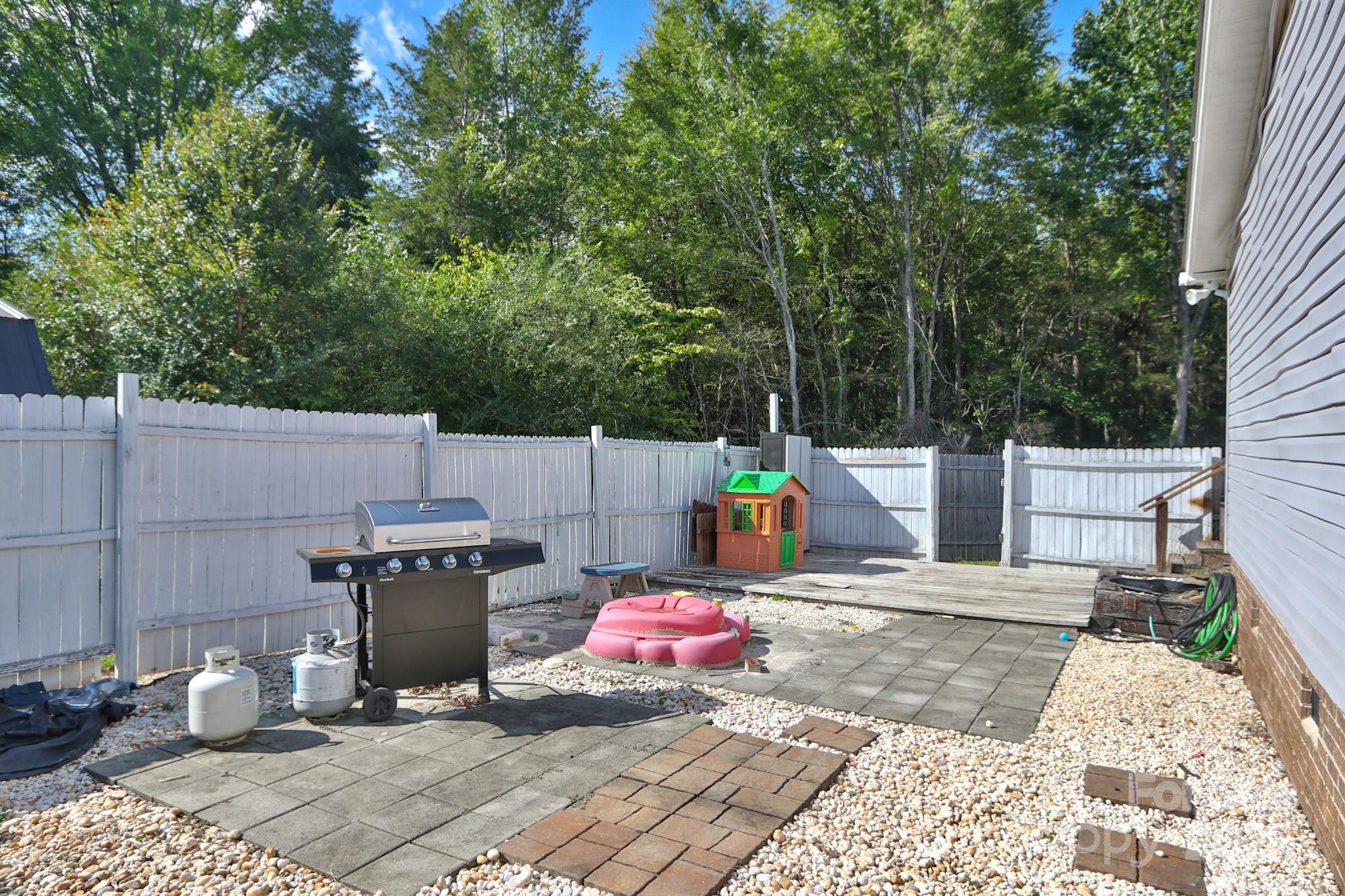 112 Courtney Road Mocksville, NC 27028 - Photo 23 of 31 a view of a patio with a table and chairs and potted plants