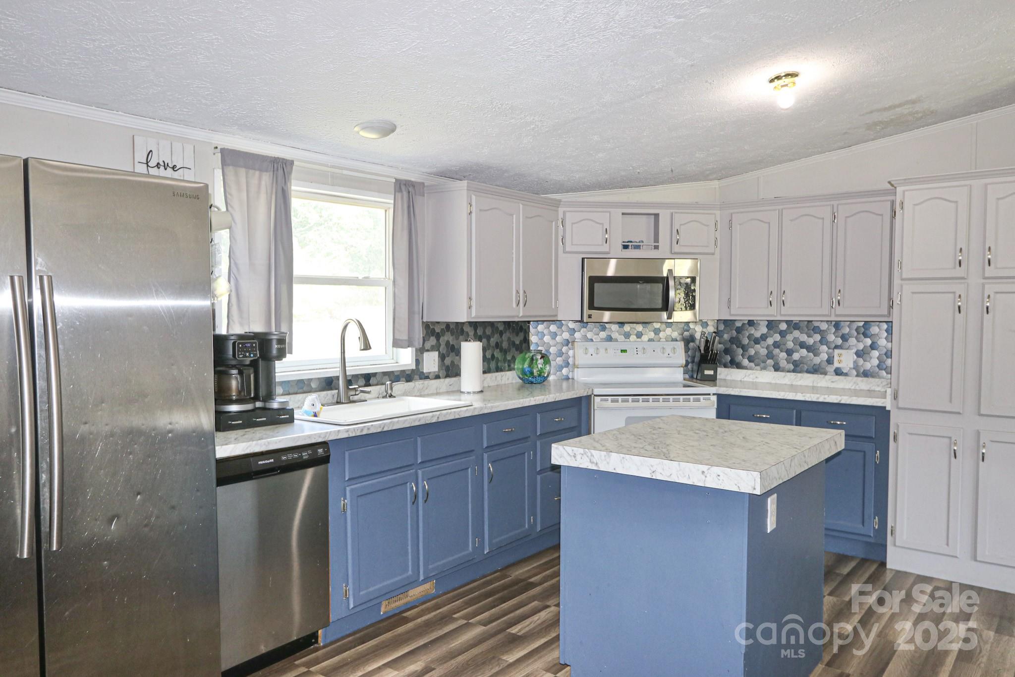 112 Courtney Road Mocksville, NC 27028 - Photo 7 of 31 a kitchen with stainless steel appliances granite countertop a sink stove and refrigerator