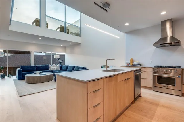 a kitchen with a sink a stove and cabinets
