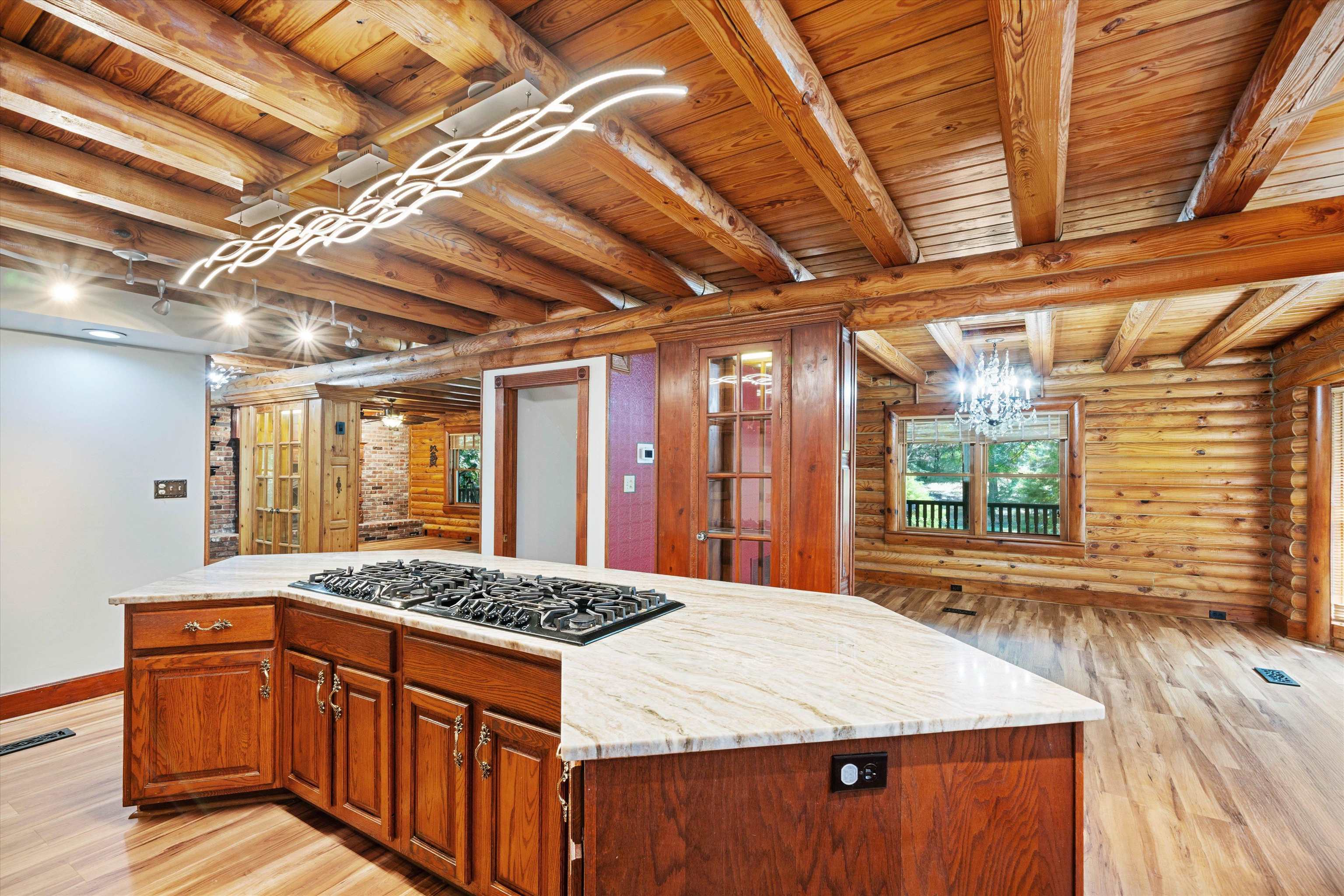 245 Metro Road Eads, TN 38028 - Photo 12 of 33 Kitchen with wood ceiling, a center island, stainless steel gas cooktop, and light wood-type flooring