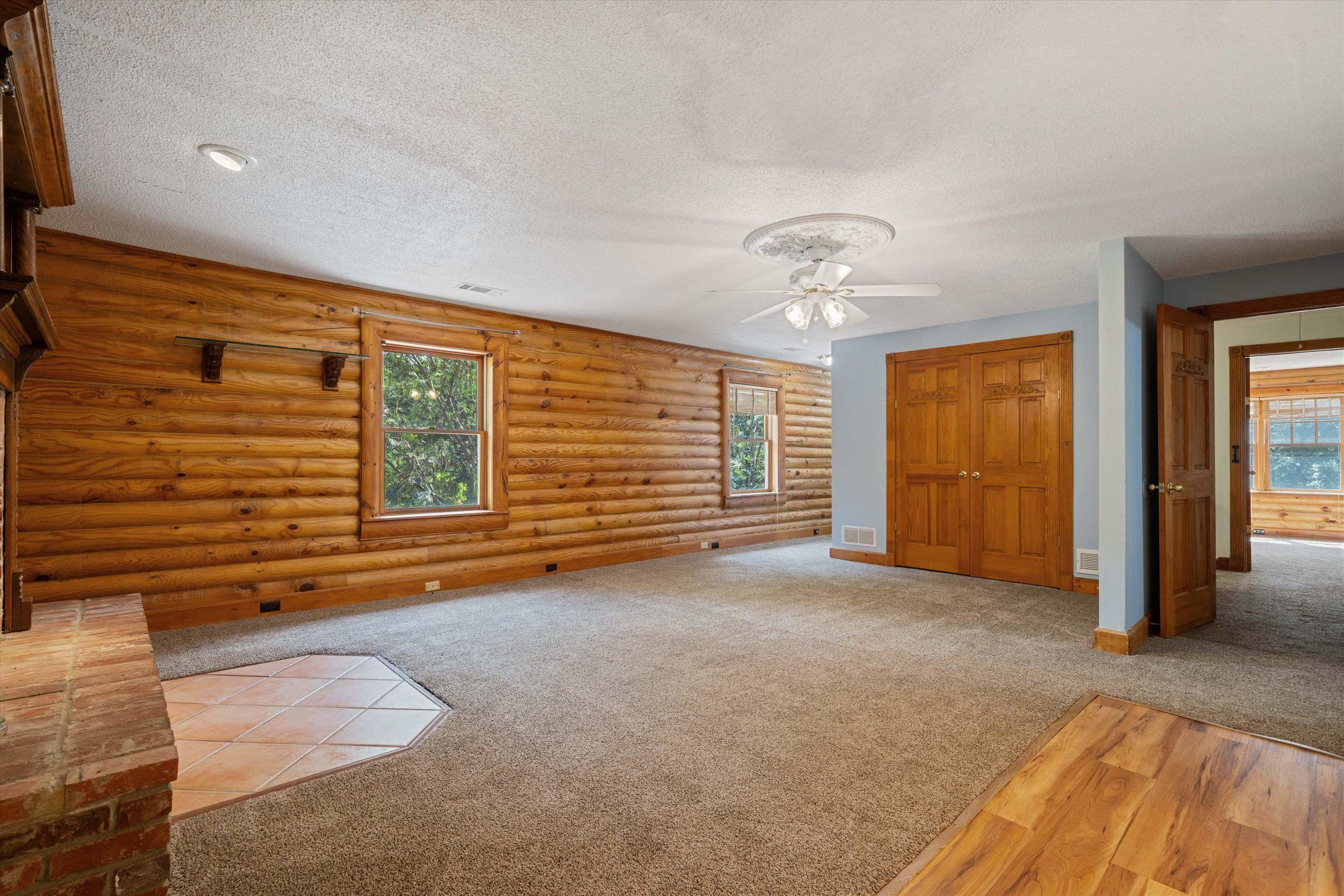 245 Metro Road Eads, TN 38028 - Photo 14 of 33 Primary Bedroom featuring plenty of natural light, log walls, and ceiling fan