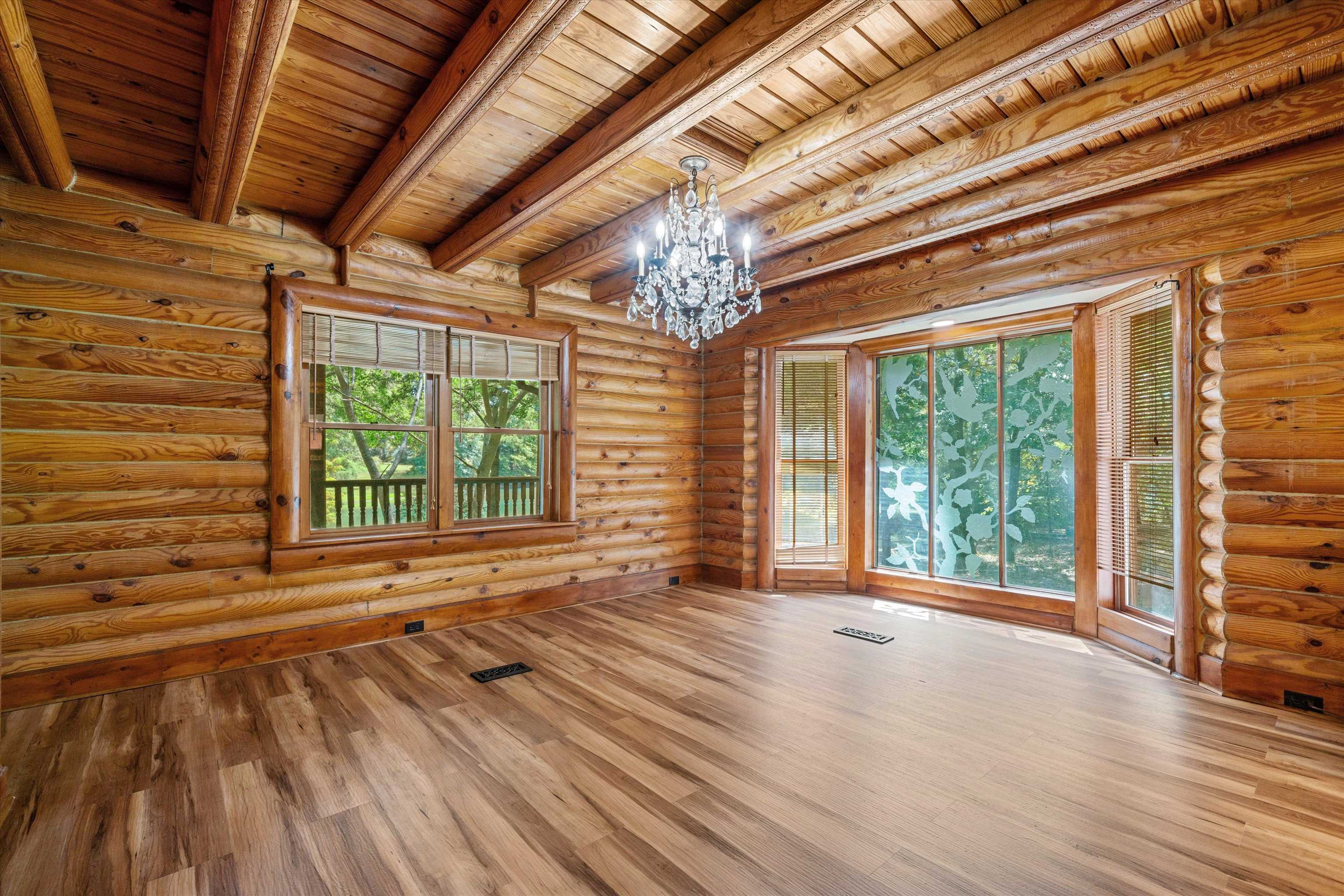 245 Metro Road Eads, TN 38028 - Photo 19 of 33 Spare room with an inviting chandelier, wood ceiling, beamed ceiling, wood-type flooring, and rustic walls