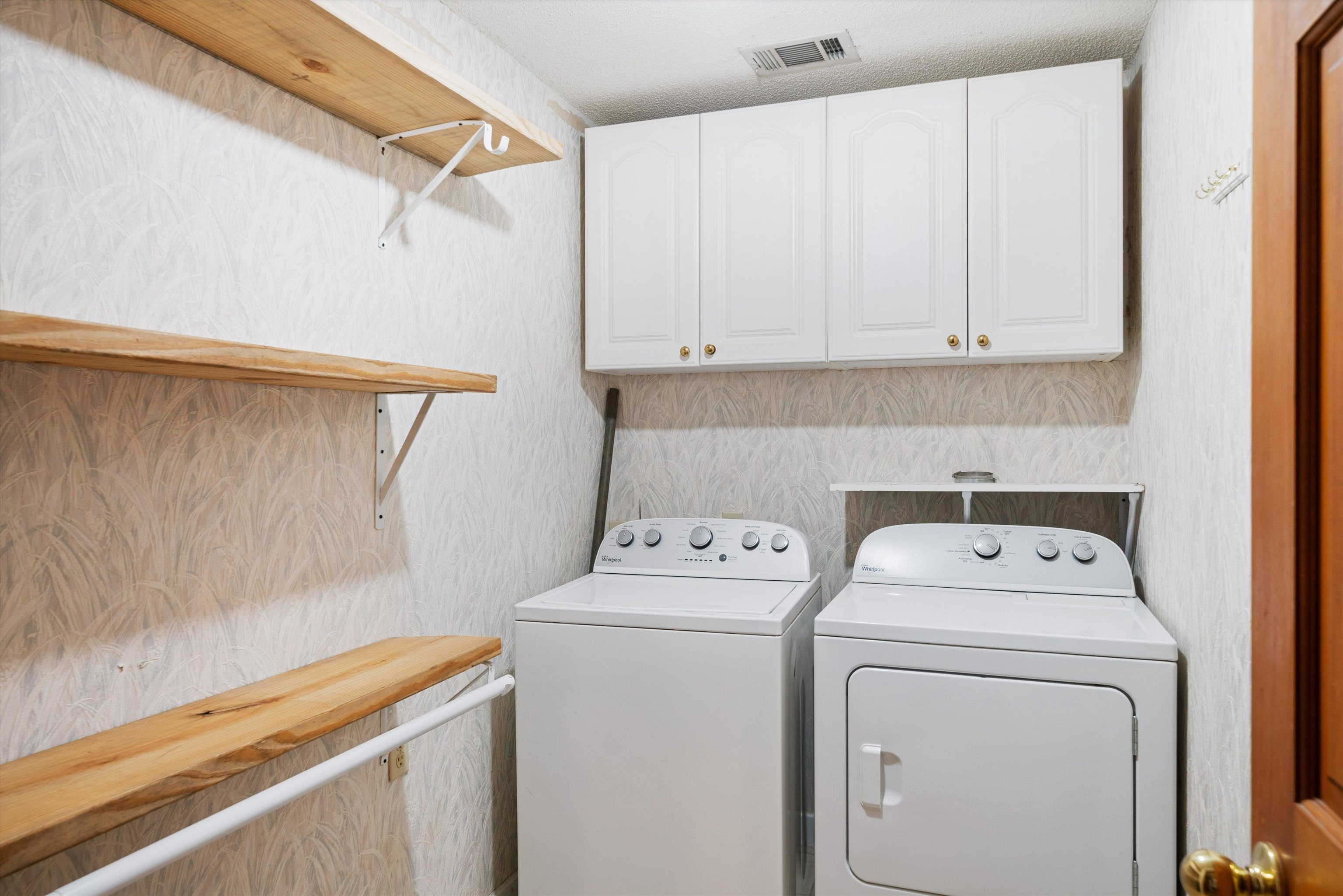 245 Metro Road Eads, TN 38028 - Photo 26 of 33 Clothes washing area with separate washer and dryer, a textured ceiling, and cabinets