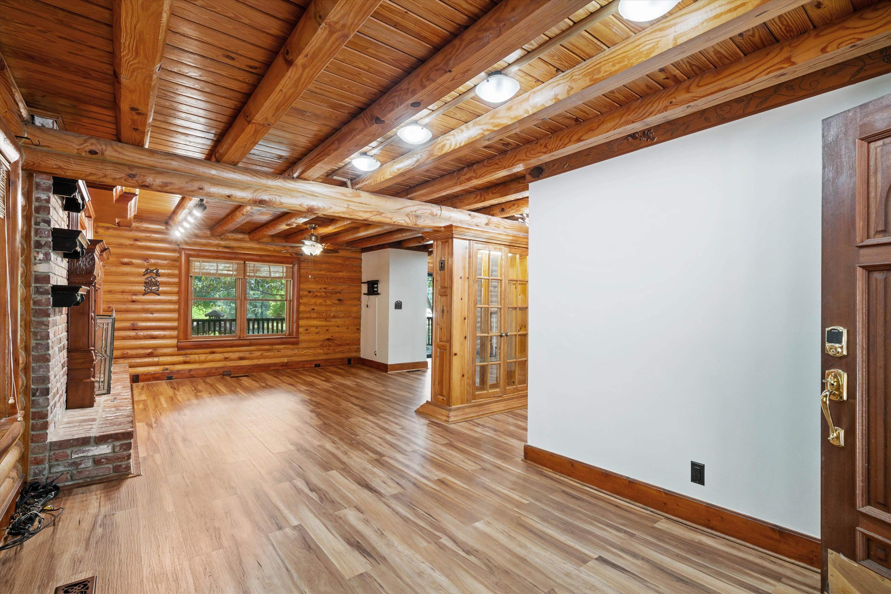 245 Metro Road Eads, TN 38028 - Photo 9 of 33 Living room with wood ceiling, a brick fireplace, beamed ceiling, and wood-style floors