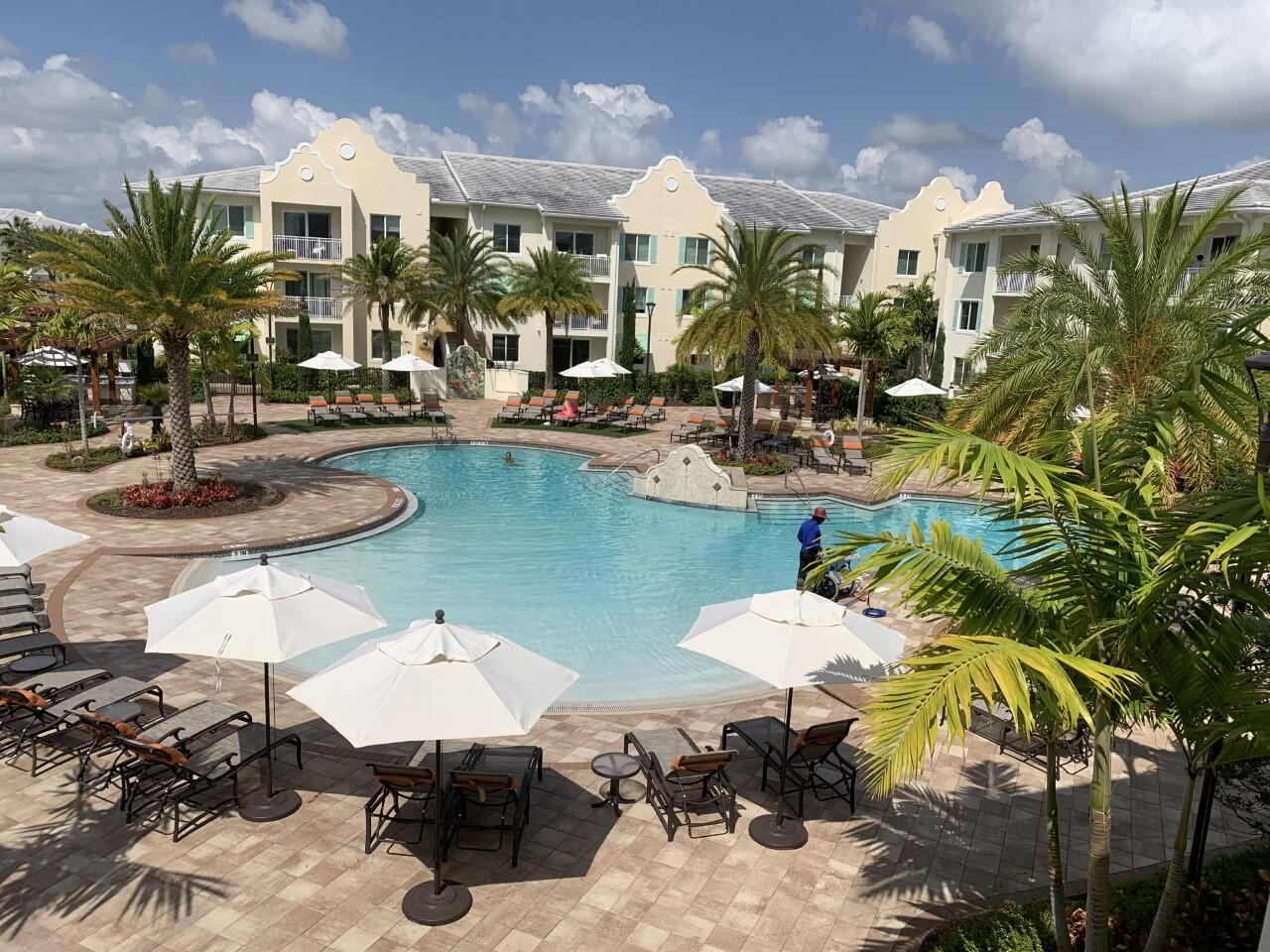1007 Water Tower Way, Unit 306 Lantana, FL 33462 - Photo 1 of 41 a view of a chairs and table in a patio