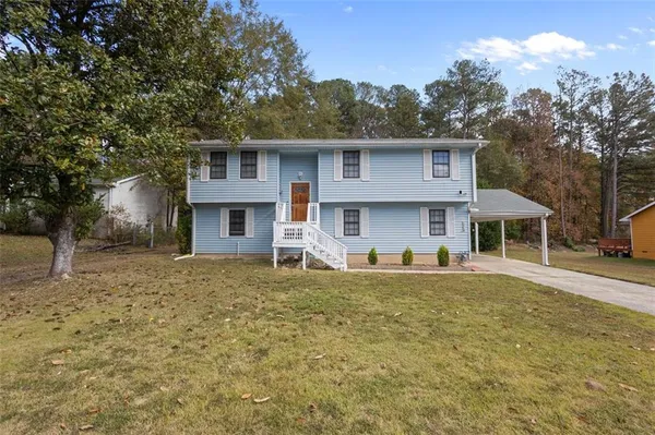 a front view of a house with a yard