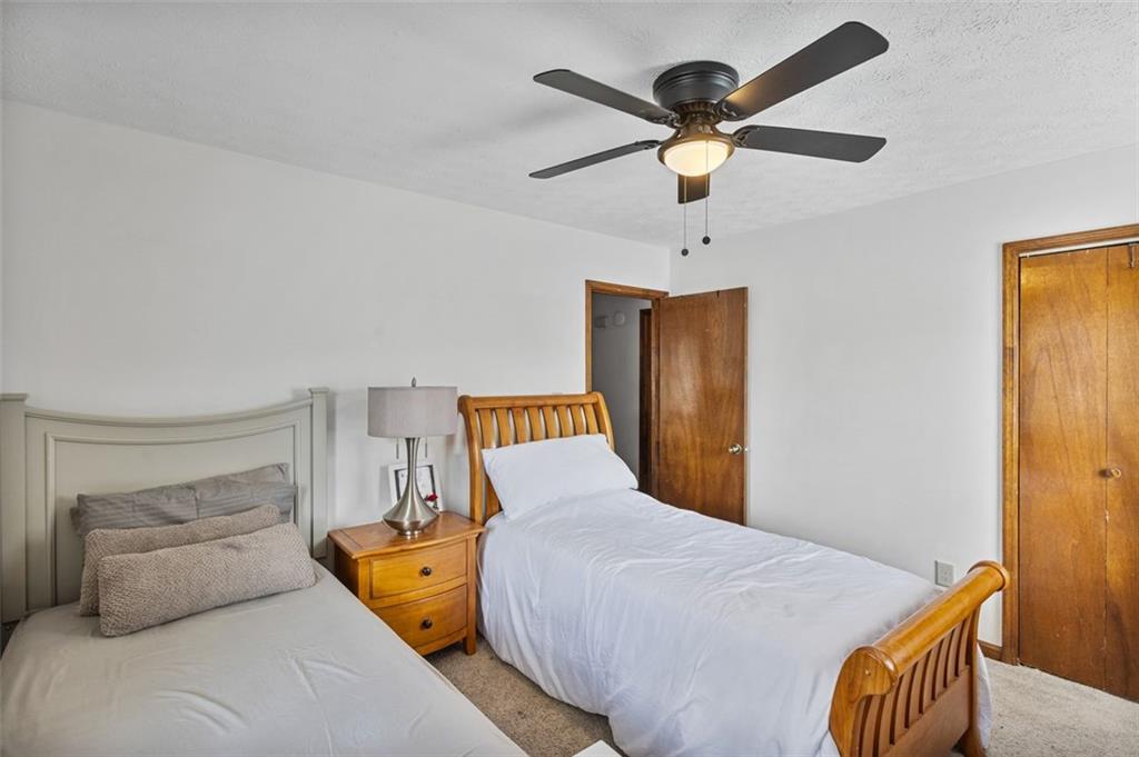 5865 Vernier Drive Southwest Atlanta, GA 30349 - Photo 16 of 33 a bedroom with bed and window