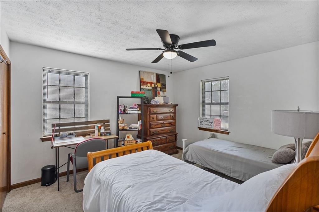 5865 Vernier Drive Southwest Atlanta, GA 30349 - Photo 17 of 33 a bedroom with furniture and a window