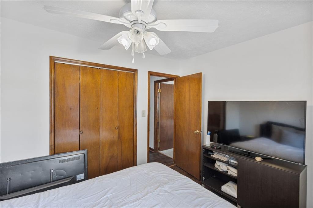 5865 Vernier Drive Southwest Atlanta, GA 30349 - Photo 18 of 33 a bedroom with a bed and a chandelier