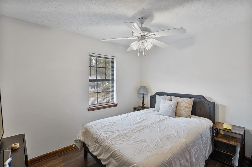 5865 Vernier Drive Southwest Atlanta, GA 30349 - Photo 19 of 33 a bedroom with a bed and wooden floor