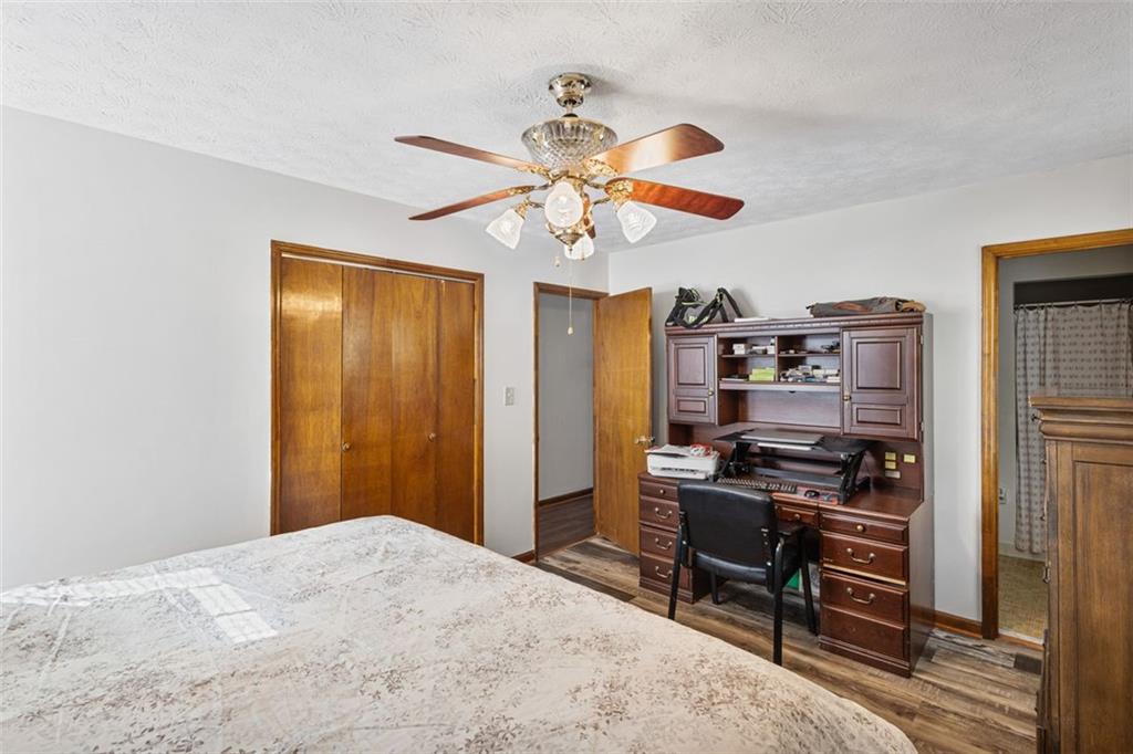 5865 Vernier Drive Southwest Atlanta, GA 30349 - Photo 21 of 33 a bedroom with a bed and a chandelier