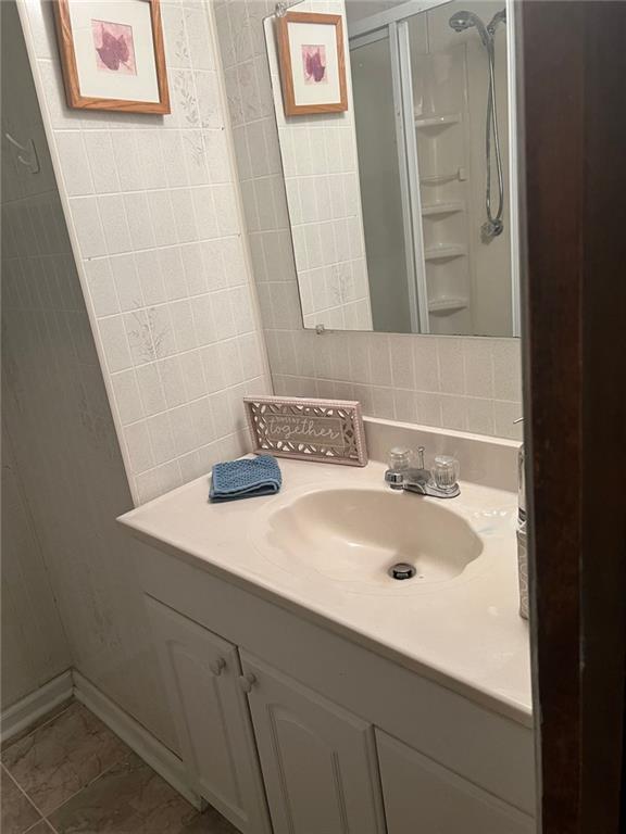 5865 Vernier Drive Southwest Atlanta, GA 30349 - Photo 26 of 33 a bathroom with a sink and a mirror