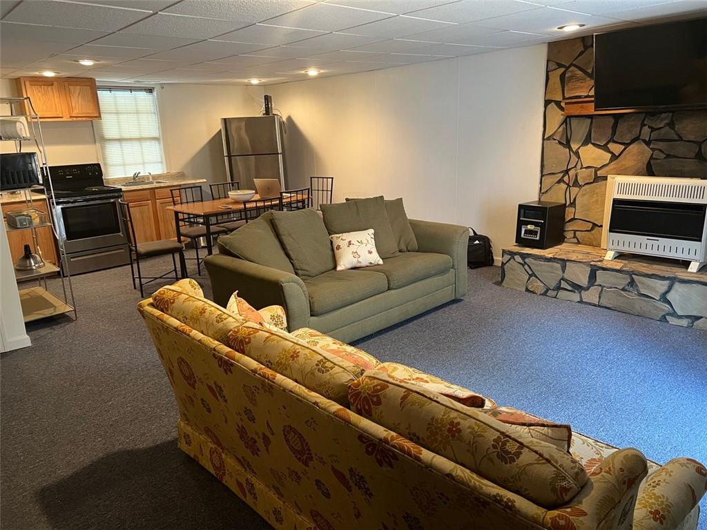 5865 Vernier Drive Southwest Atlanta, GA 30349 - Photo 29 of 33 a living room with furniture a flat screen tv and kitchen view