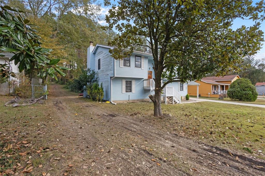 5865 Vernier Drive Southwest Atlanta, GA 30349 - Photo 3 of 33 a front view of a house with a yard