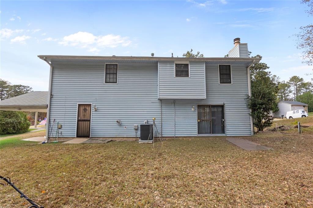 5865 Vernier Drive Southwest Atlanta, GA 30349 - Photo 31 of 33 a front view of a house with a yard