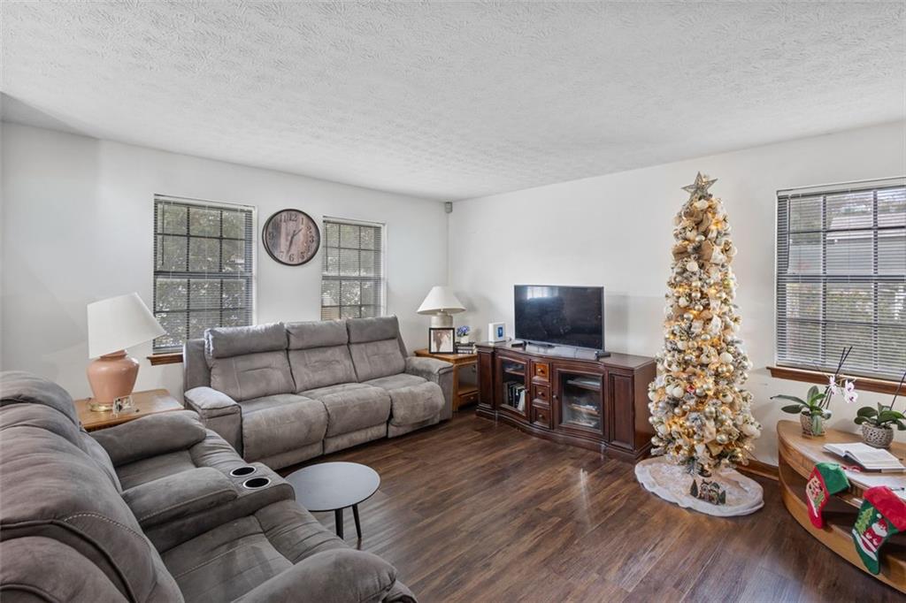 5865 Vernier Drive Southwest Atlanta, GA 30349 - Photo 6 of 33 a living room with furniture and a flat screen tv