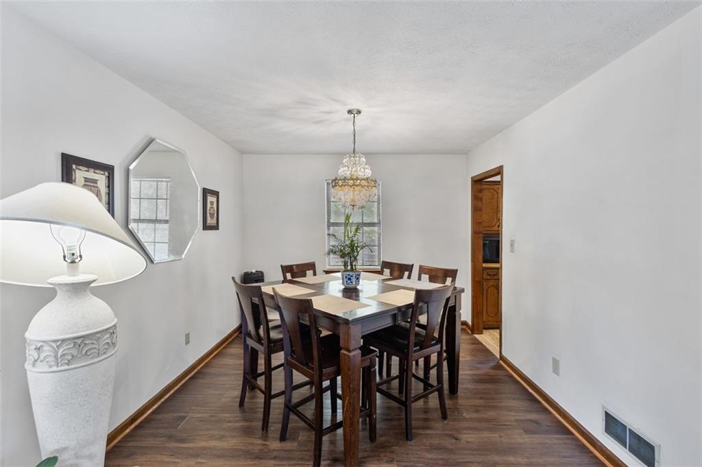 5865 Vernier Drive Southwest Atlanta, GA 30349 - Photo 9 of 33 a view of a dining room with furniture and wooden floor