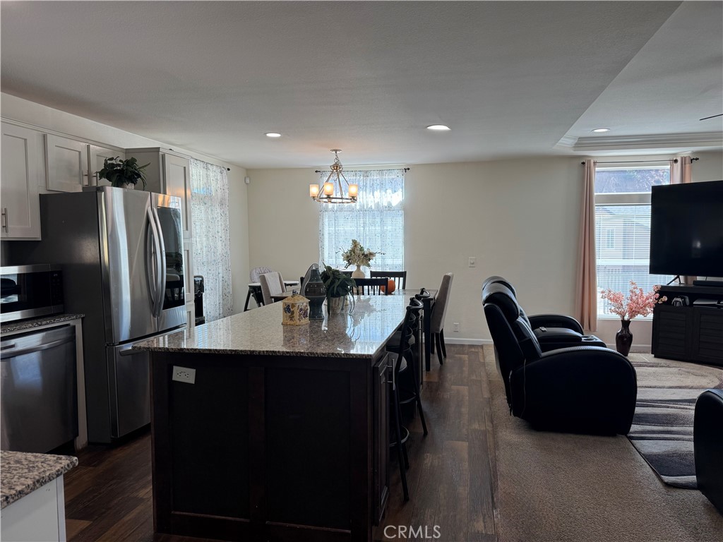 657 Lebec Road, Unit 36 Lebec, CA 93243 - Photo 6 of 20 a kitchen with stainless steel appliances granite countertop a refrigerator a sink a stove a dining table and chairs