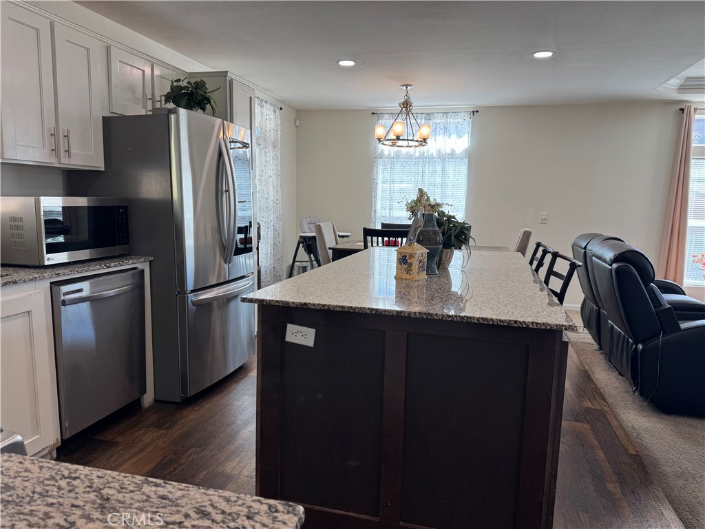 657 Lebec Road, Unit 36 Lebec, CA 93243 - Photo 7 of 20 a kitchen with refrigerator cabinets and wooden floor