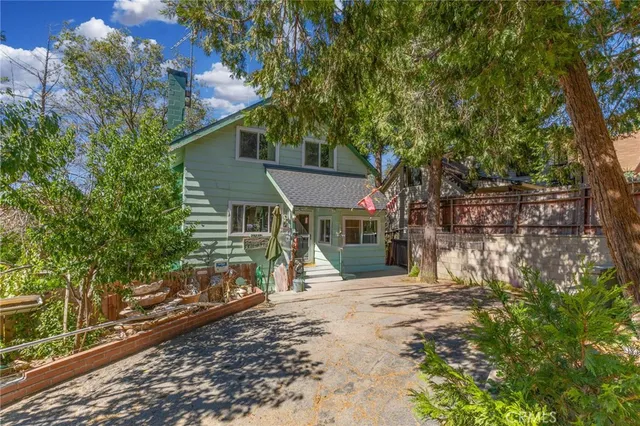 a view of a house with a tree in the background