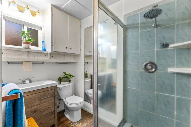 a bathroom with a toilet sink and shower