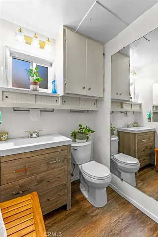 a bathroom with a toilet a sink and a window
