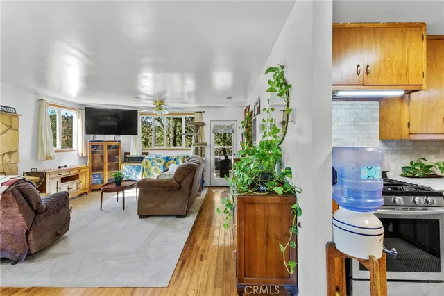 a living room with furniture a chandelier and a wooden floor