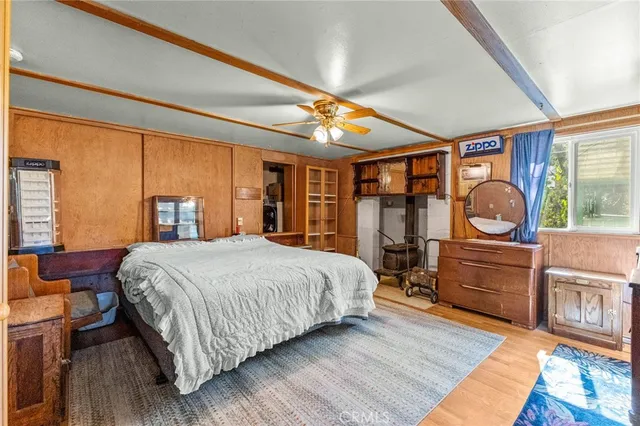 a bedroom with a bed and a dresser next to a window