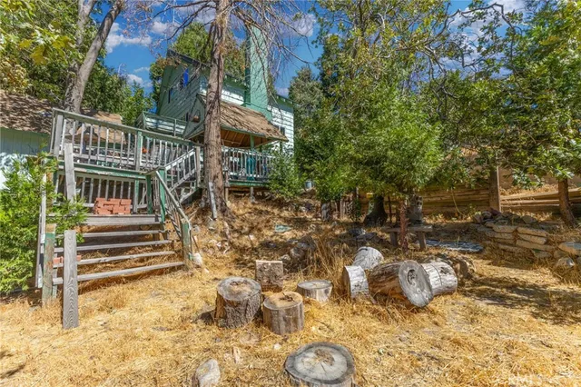 a view of a house with a yard covered in snow