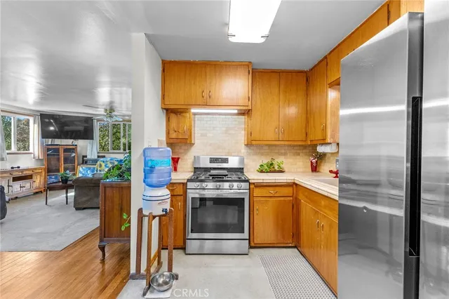 a kitchen with stainless steel appliances granite countertop a stove and a refrigerator