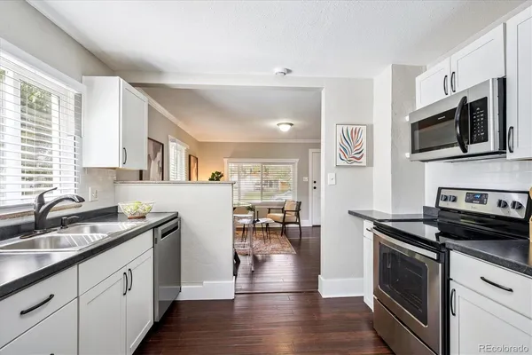 a kitchen with stainless steel appliances a stove sink microwave and cabinets