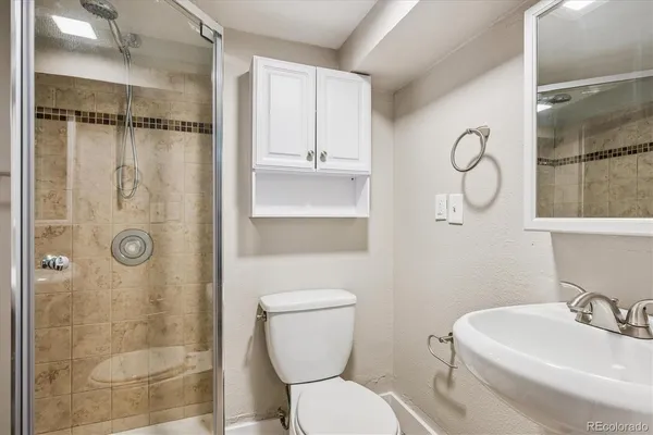 a bathroom with a toilet sink and shower