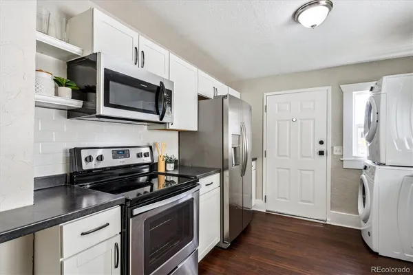 a kitchen with stainless steel appliances a stove microwave and refrigerator