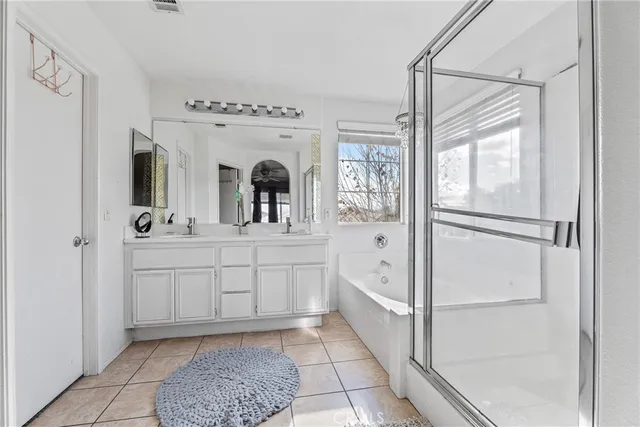 a bathroom with a sink a mirror and a shower