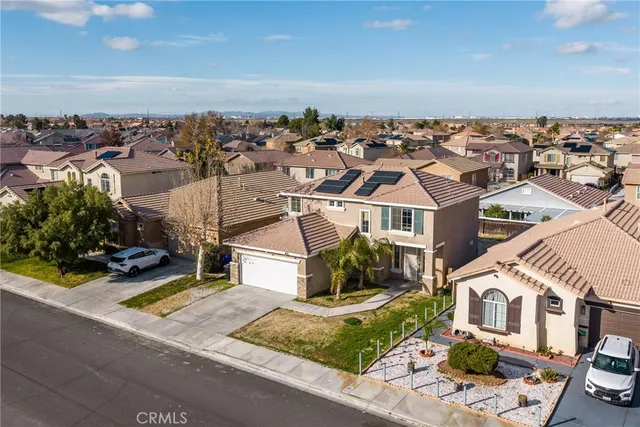 an aerial view of a house with a garden and balcony