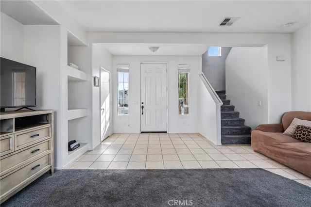 a view of a livingroom with furniture and stairs