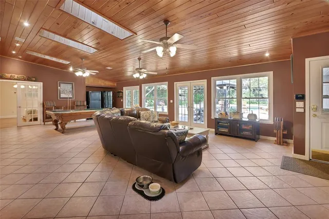 a room with pool table and windows