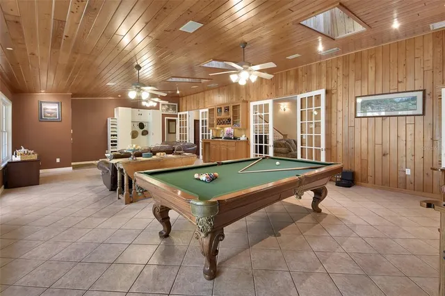 a kitchen with granite countertop a sink a stove top oven a counter space and cabinets