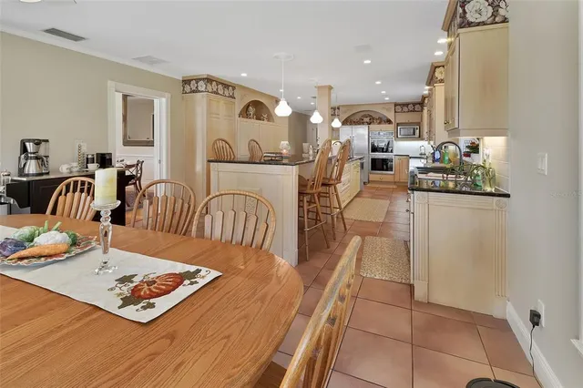 a kitchen with white cabinets appliances and a sink