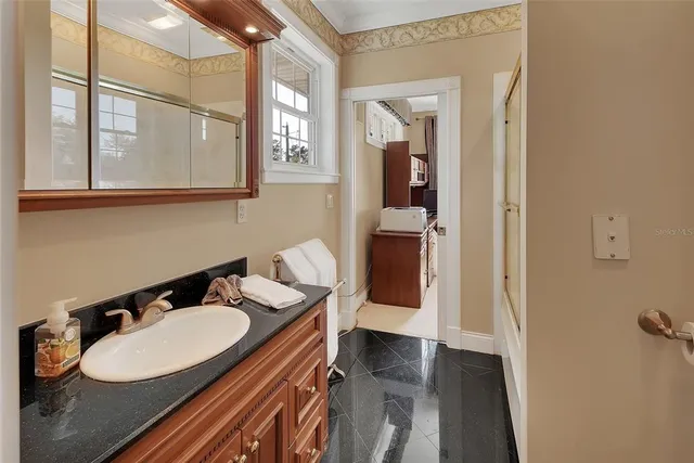 a bathroom with a sink toilet and mirror