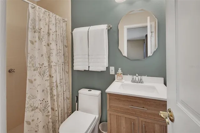 a bathroom with a glass shower door