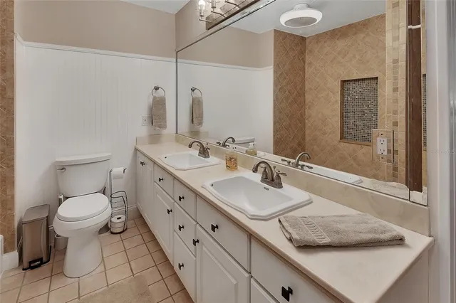 a kitchen with stainless steel appliances kitchen island granite countertop a refrigerator and a stove top oven